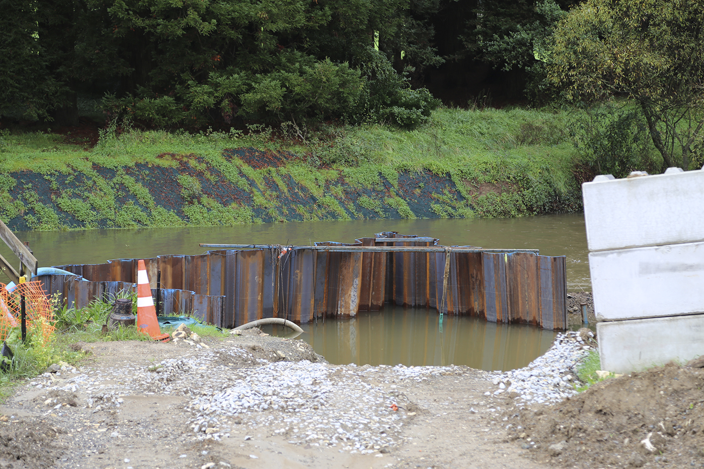 Sheet piling is being used to keep the river water out of the work site.